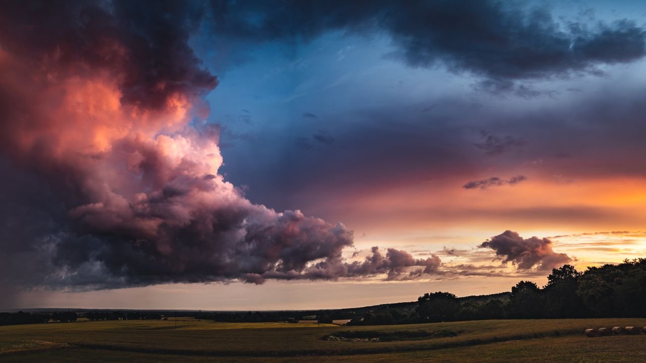 Crafting Captivating Headlines: Your awesome post title goes here Breathtaking twilight sky over a serene Polish countryside, capturing cloudscape and vibrant colors.
